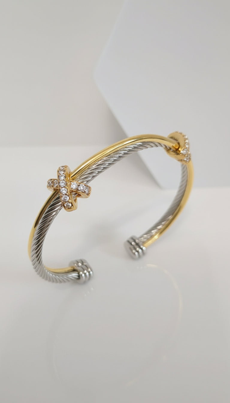 Two-toned gold and silver bracelet on a white background