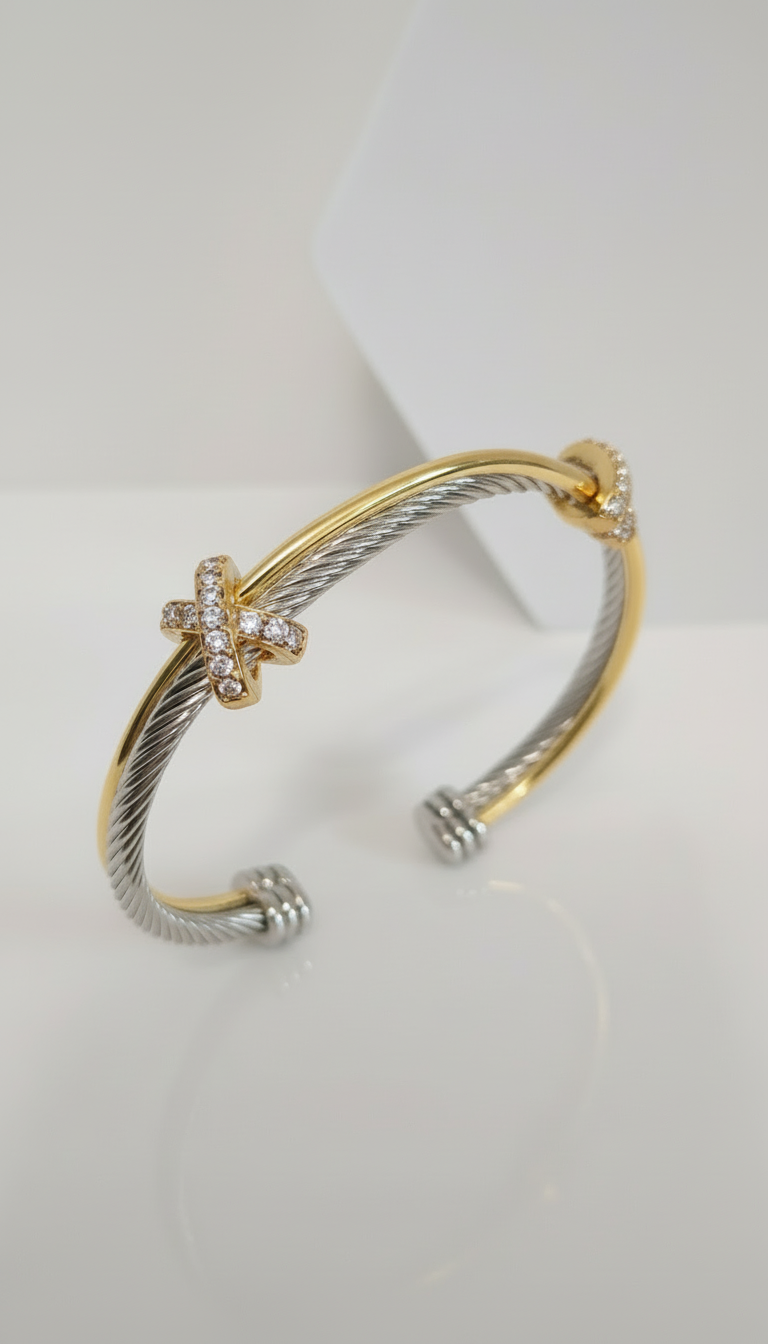 Two-toned gold and silver bracelet on a white background