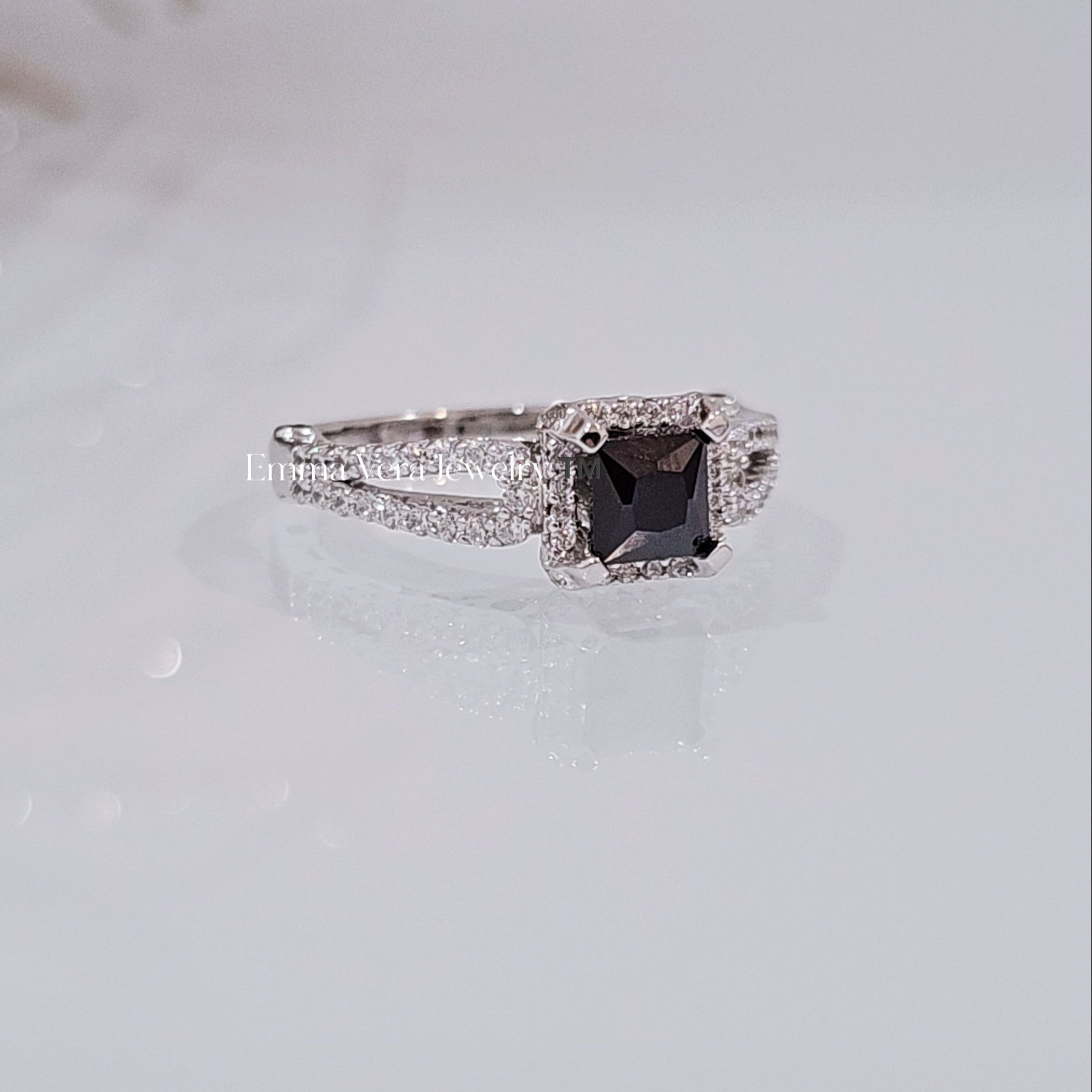 This image features an elegant sterling silver ring with a princess cut sapphire centerpiece. The ring's design is modern, showcasing a sleek, square cut with pointed corners and brilliant facets that enhance its exceptional sparkle.